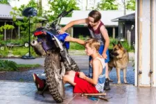 Children with a motocross in the garage